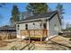 Charming gray home featuring a cozy front porch and red front door, all under a clear blue sky at 102 Dahlia Nw Ave, Atlanta, GA 30314