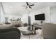Bright living room featuring modern decor, a ceiling fan, and an open view of the kitchen at 102 Dahlia Nw Ave, Atlanta, GA 30314