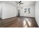 Bright, minimalist living room with hardwood floors and a large window offering natural light at 102 Dahlia Nw Ave, Atlanta, GA 30314