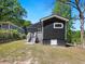 The backyard features a dark exterior with a staircase and trees at 1599 Ezra Church Nw Dr, Atlanta, GA 30314