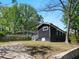 Backyard with dark siding, a grassy yard, mature trees, and a retaining wall for curb appeal at 1599 Ezra Church Nw Dr, Atlanta, GA 30314