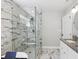 Bathroom featuring a glass-enclosed shower, modern fixtures, and sleek marble tiling at 1599 Ezra Church Nw Dr, Atlanta, GA 30314
