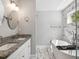 Bright bathroom featuring double sinks, granite countertops, and a luxurious soaking tub at 1599 Ezra Church Nw Dr, Atlanta, GA 30314