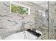 Elegant bathroom showcasing a soaking tub and a glass-enclosed shower with marble tile at 1599 Ezra Church Nw Dr, Atlanta, GA 30314