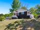A cozy home features a manicured lawn, and a stylish black and grey exterior at 1599 Ezra Church Nw Dr, Atlanta, GA 30314