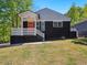 Charming home boasts dark brick, a welcoming porch, and a vibrant orange door at 1599 Ezra Church Nw Dr, Atlanta, GA 30314