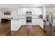 Beautiful open kitchen features white cabinets, stainless steel appliances, and granite countertops at 1599 Ezra Church Nw Dr, Atlanta, GA 30314