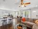 Open concept living space with hardwood floors and a breakfast bar separating the kitchen at 1599 Ezra Church Nw Dr, Atlanta, GA 30314