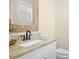 Updated bathroom with granite counters, white cabinets, and decorative wood mirror at 1908 Weston Ln, Tucker, GA 30084