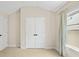Bright bedroom with large window, tan carpet and double door closet at 1908 Weston Ln, Tucker, GA 30084