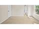 Bright bedroom featuring neutral walls, tan carpet, closet door and entry to the bathroom at 1908 Weston Ln, Tucker, GA 30084