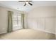 Spacious bedroom featuring neutral walls, tan carpet and large window at 1908 Weston Ln, Tucker, GA 30084