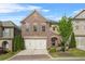 Charming two-story brick home featuring a two-car garage and a beautifully landscaped front yard at 1908 Weston Ln, Tucker, GA 30084