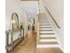 Inviting foyer with hardwood floors, staircase, console table, and a glimpse of the living area at 1908 Weston Ln, Tucker, GA 30084