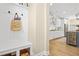 Elegant foyer with hall tree, hardwood floors, and a view into the gourmet kitchen at 1908 Weston Ln, Tucker, GA 30084