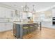 Gourmet kitchen with a large island, stainless steel appliances, and modern lighting fixtures at 1908 Weston Ln, Tucker, GA 30084