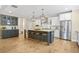 Bright eat-in kitchen with stainless appliances, island with seating, and modern lighting at 1908 Weston Ln, Tucker, GA 30084
