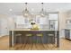Modern kitchen featuring a large island with seating, stainless steel appliances, and ample cabinet space at 1908 Weston Ln, Tucker, GA 30084