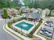 Community pool with a covered area with tables surrounded by lush landscaping and convenient parking spaces at 1908 Weston Ln, Tucker, GA 30084
