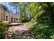 Secluded backyard featuring a stone pathway, lush greenery, and a cozy deck at 3573 Turtle Cove Se Ct, Marietta, GA 30067
