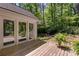 Serene backyard deck with French doors leading indoors, surrounded by lush greenery at 3573 Turtle Cove Se Ct, Marietta, GA 30067