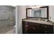 Elegant bathroom featuring granite countertops, dark wood cabinets, and a glass shower at 3573 Turtle Cove Se Ct, Marietta, GA 30067
