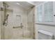 Modern bathroom with glass shower, seat, handheld sprayer and natural light at 3573 Turtle Cove Se Ct, Marietta, GA 30067