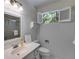 Bright bathroom featuring beadboard walls, white fixtures, a shower and a sunlit window at 3573 Turtle Cove Se Ct, Marietta, GA 30067