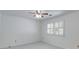 Minimalist bedroom with neutral carpet, white walls, and a window with shutters at 3573 Turtle Cove Se Ct, Marietta, GA 30067