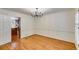 Formal dining room featuring hardwood floors, chandelier, and white wainscoting, adjacent to the kitchen at 3573 Turtle Cove Se Ct, Marietta, GA 30067