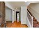 Inviting foyer showcasing hardwood floors, a staircase, and a view into adjacent rooms with crisp, white trim at 3573 Turtle Cove Se Ct, Marietta, GA 30067