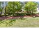 A classic brick home framed by lush greenery and mature trees on a sprawling lawn at 3573 Turtle Cove Se Ct, Marietta, GA 30067