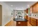 Bright kitchen with dark countertop island, hardwood floors, stainless sink, and light wood cabinets at 3573 Turtle Cove Se Ct, Marietta, GA 30067