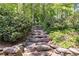 Stone steps winding through a lush garden, blending natural beauty and architectural elegance at 3573 Turtle Cove Se Ct, Marietta, GA 30067