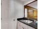 Charming wet bar features a stainless steel sink with black granite countertop and white cabinets at 3573 Turtle Cove Se Ct, Marietta, GA 30067