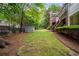 Beautiful backyard with lush greenery, a playhouse, and a private fence at 492 Conway Manor Nw Dr, Atlanta, GA 30327