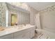 Bathroom featuring classic floral wallpaper, a large mirror, and a shower-tub combination at 492 Conway Manor Nw Dr, Atlanta, GA 30327