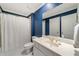 Blue accent wallpaper in bathroom with a built-in vanity and mirror at 492 Conway Manor Nw Dr, Atlanta, GA 30327