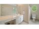 Bathroom with white cabinetry, expansive vanity area, and an oval window above the toilet at 492 Conway Manor Nw Dr, Atlanta, GA 30327