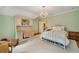 Spacious bedroom with chandelier, desk, and vintage-style furniture on carpet and hardwood at 492 Conway Manor Nw Dr, Atlanta, GA 30327