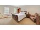 Cozy bedroom featuring a wood-framed bed, two windows, and ample space for storage at 492 Conway Manor Nw Dr, Atlanta, GA 30327