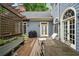 A cozy deck with wooden furniture, a grill, and elegant plants, perfect for outdoor relaxation and entertainment at 492 Conway Manor Nw Dr, Atlanta, GA 30327