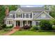 Charming two-story home with blue siding, dark shutters, inviting front porch and lush landscaping at 492 Conway Manor Nw Dr, Atlanta, GA 30327