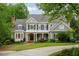 Beautiful two-story home featuring blue siding, dark shutters, a welcoming front porch, and a well-manicured lawn at 492 Conway Manor Nw Dr, Atlanta, GA 30327