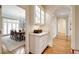 Hallway with hardwood floors and built-in cabinet looking to adjacent dining room with natural light at 492 Conway Manor Nw Dr, Atlanta, GA 30327