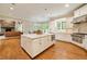 Spacious kitchen features a large center island, hardwood floors, stainless steel appliances, and great natural light at 492 Conway Manor Nw Dr, Atlanta, GA 30327
