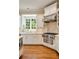 Bright kitchen features stainless steel appliances, a window above the sink, and custom white cabinets at 492 Conway Manor Nw Dr, Atlanta, GA 30327