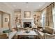An inviting living room boasts a fireplace, built-in shelves, stylish furnishings and a large arched window at 492 Conway Manor Nw Dr, Atlanta, GA 30327