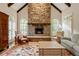 Stunning living room featuring soaring ceilings, a beautiful stone fireplace, and lots of natural light at 492 Conway Manor Nw Dr, Atlanta, GA 30327