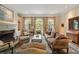 Elegant living room features a fireplace, arched windows, custom curtains, and detailed molding at 492 Conway Manor Nw Dr, Atlanta, GA 30327